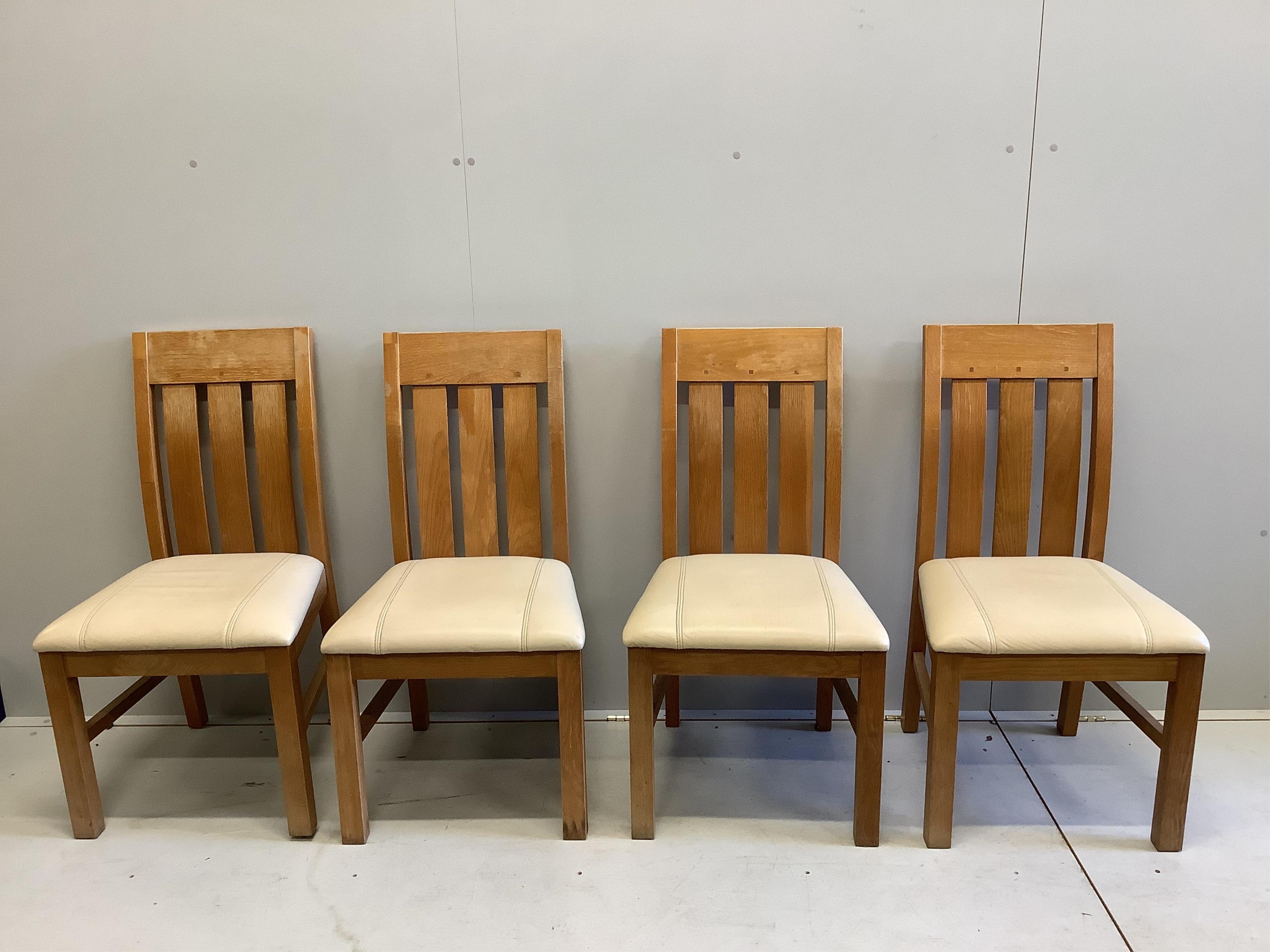 A modern pine kitchen table and four golden oak chairs, width 152cm, depth 93cm. Condition - some staining to the table top, wear and fading to the chairs